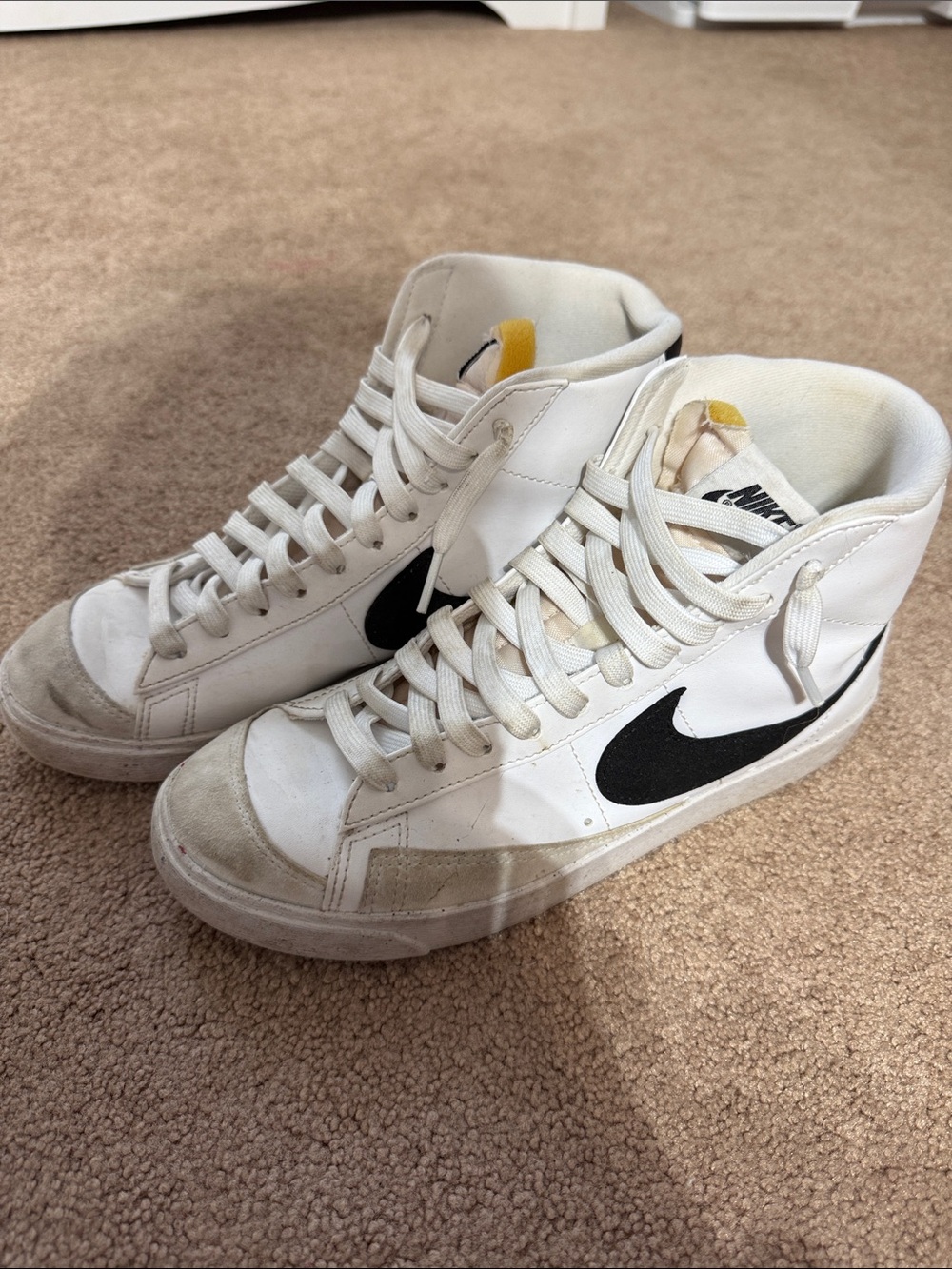 Nike White High-Top Sneakers with Black Swoosh and Yellow Tongue Detail